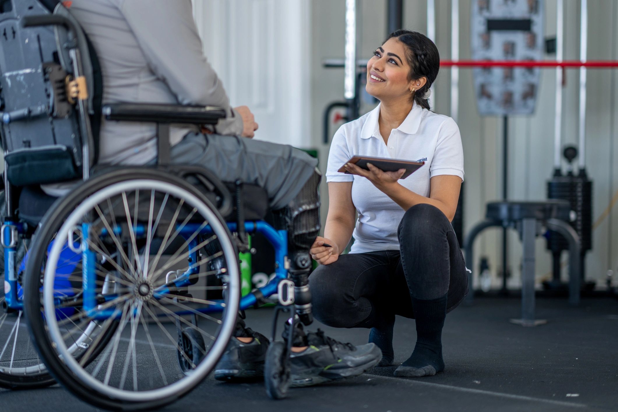 Clinician consulting with a wheelchair user during a mobility evaluation