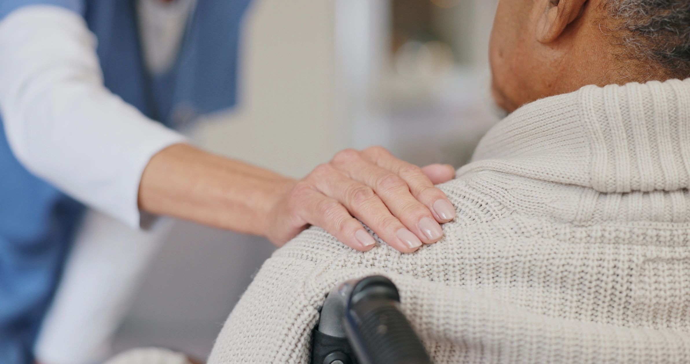 Clinician supporting a wheelchair user during seating consultation