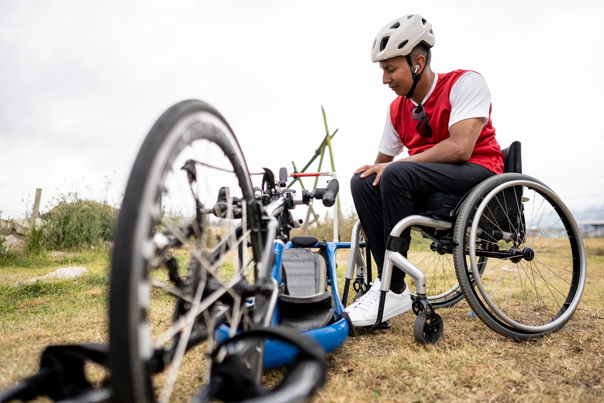 Wheelchair user preparing mobility equipment outdoors